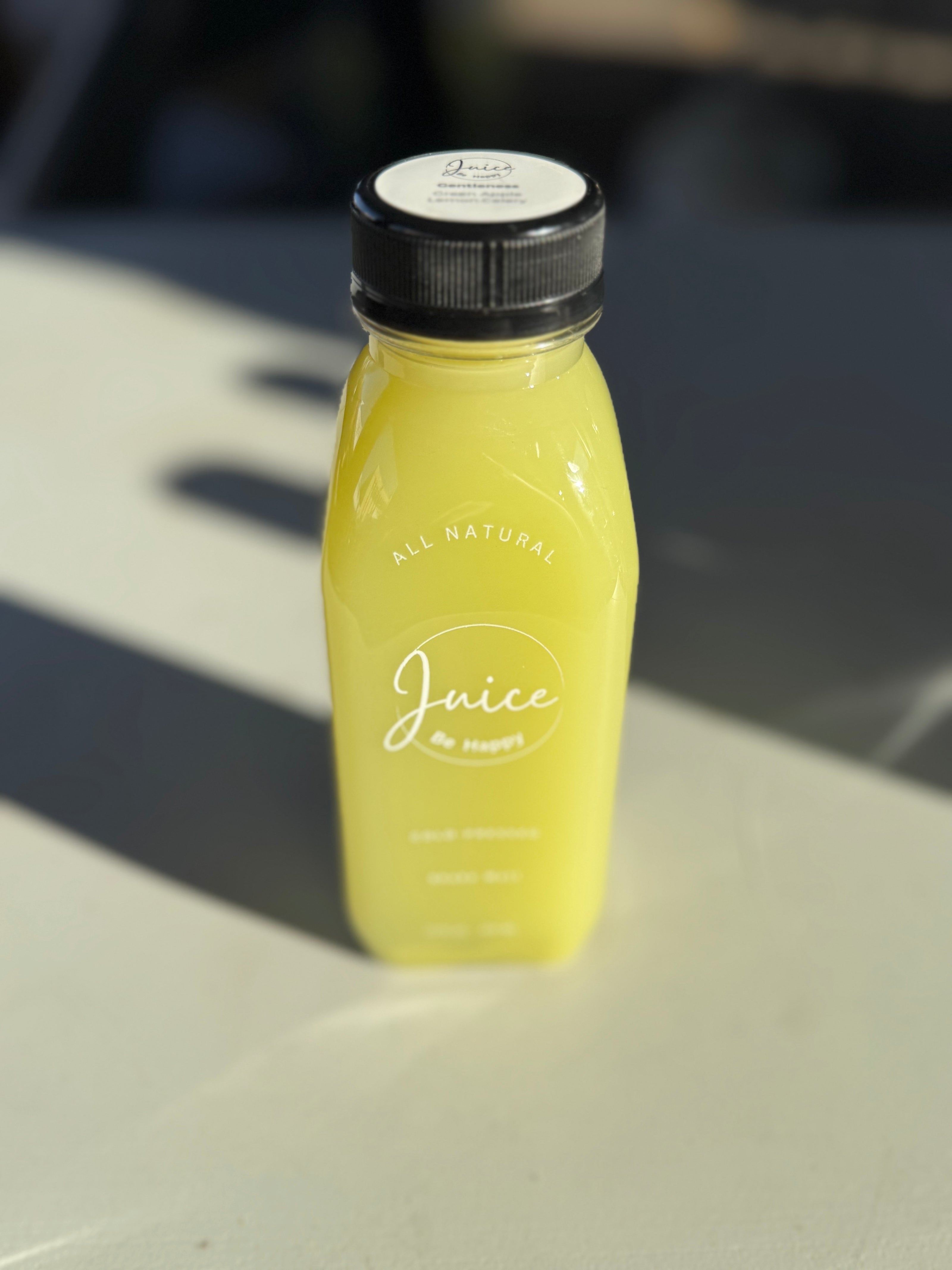 Juice Be Happy Gentleness blend cold pressed celery, green apple, and lemon juice in a glass bottle for hydration and digestion support.