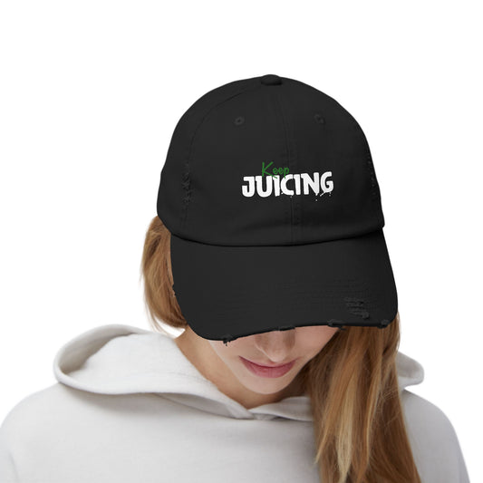 Black cap with 'Keep Juicing' text worn by a person on a white background