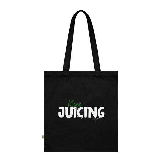 Black tote bag with 'Keep Juicing' text on a white background