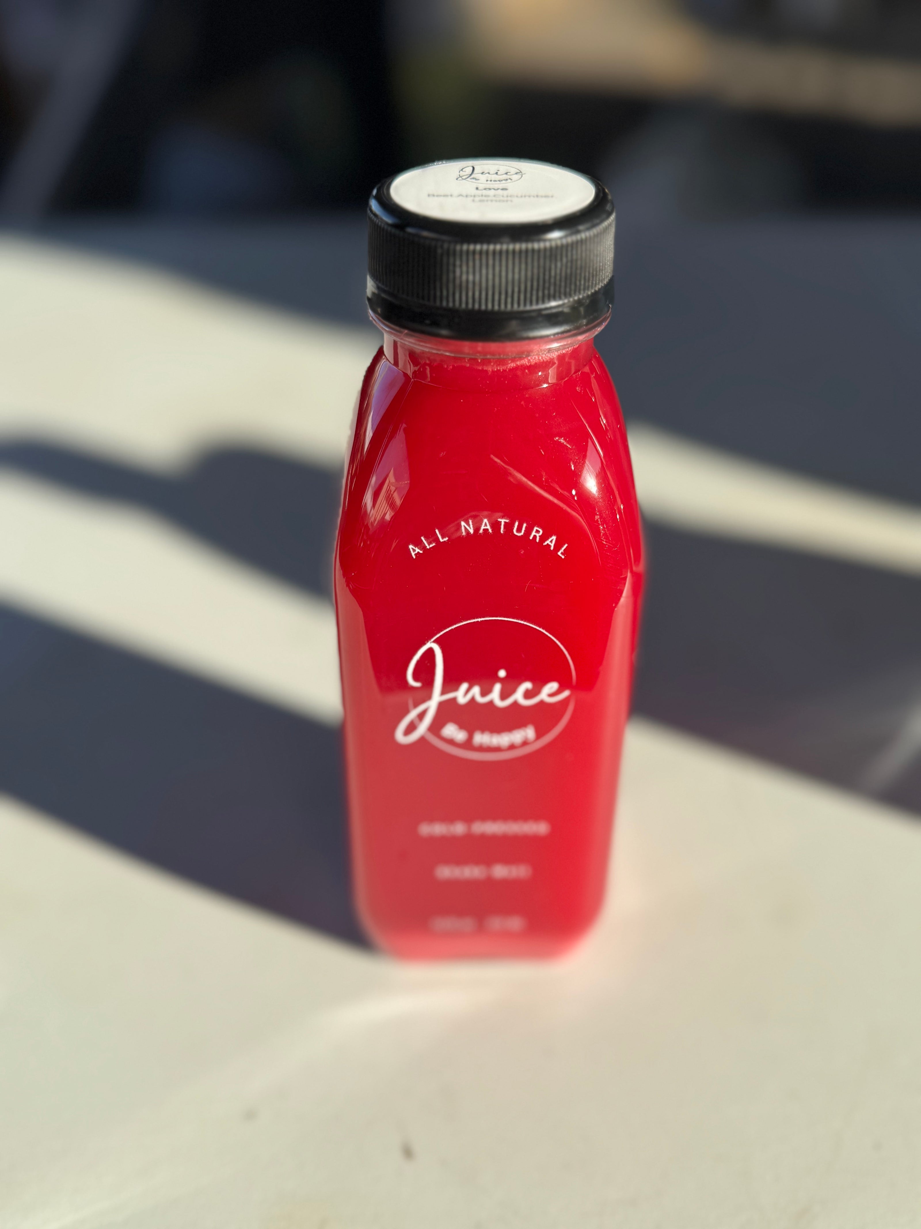 Juice Be Happy Love blend  cold pressed beet, lemon, cucumber, and apple juice in a glass bottle for heart health and detox.