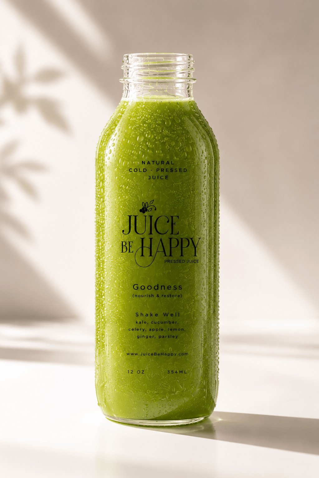 Juice Be Happy Goodness cold-pressed green juice bottle clean studio shot — kale, cucumber, celery, apple, lemon, ginger, parsley — 12 oz